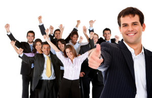 Business man leading a successful corporate group with thumbs up